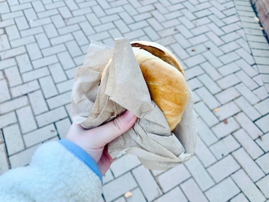 Taking a bagel from the IDX Dining Hall outside. Photo by: Katherine Townsend.