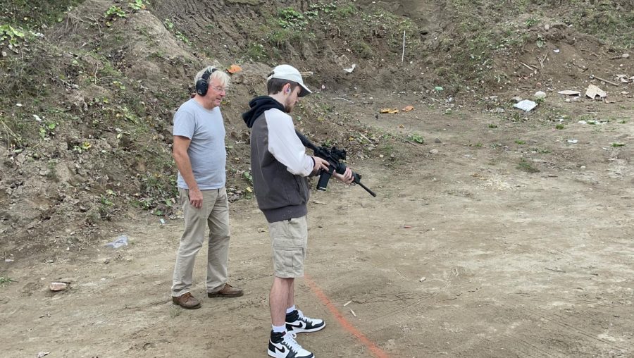 Vice President Henry Foley learning to shoot an AR-15 with instructor Ciaran Buckley. Photo Location: Laberges Farm
