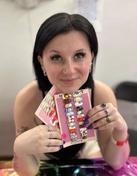 Cecelia Diorio poses with her custom press on nails that she sells through her small business, Cici's Nails.